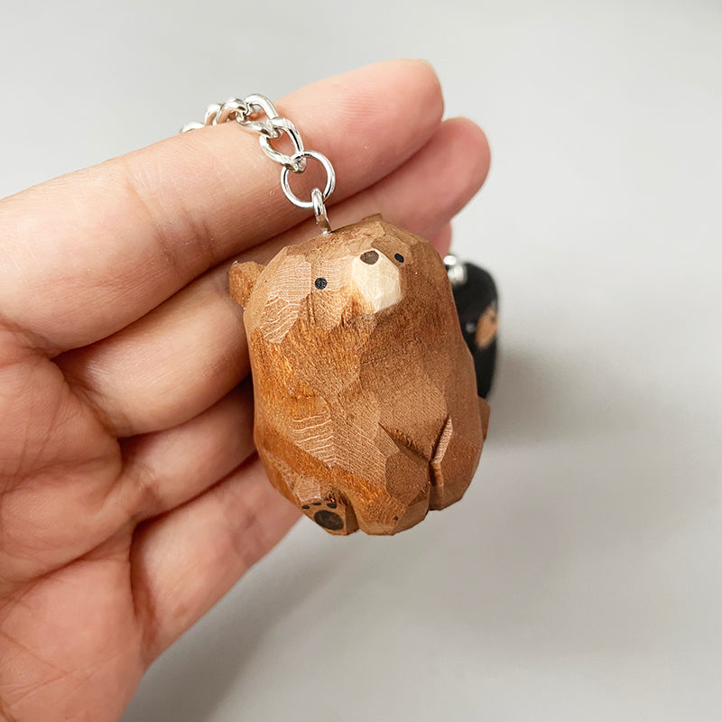 Close-up of a hand holding a bear keychain