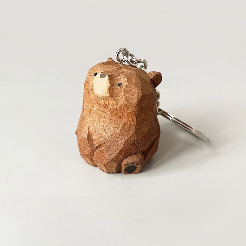 Side view of adorable wooden bear keychain with metal ring