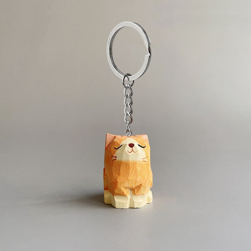 Front view of a cute cat keychain, orange cat style, hand-carved in wood