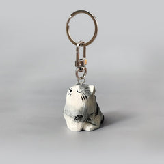 Adorable hand-carved wooden cat keychain with a happy expression