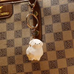 Adorable sheep keychain attached to a khaki bag