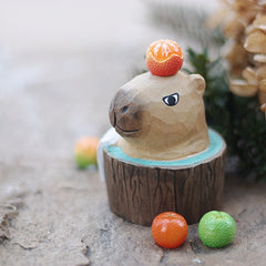 A bubble bath styled capybara figure placed in an outdoor scene.