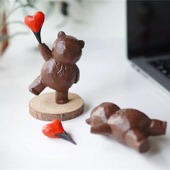 Wood sculpture bear with heart balloon, hand-carved wooden figure.