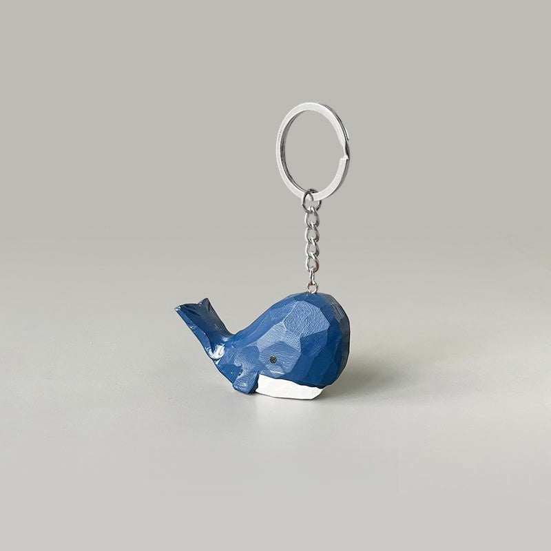 Hand-carved big head blue whale keychain, featuring a cartoon style with dark blue and white colors.