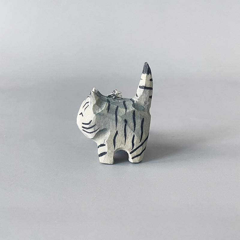 Rear view of black stripe gray cat keychain showing its striped tail.