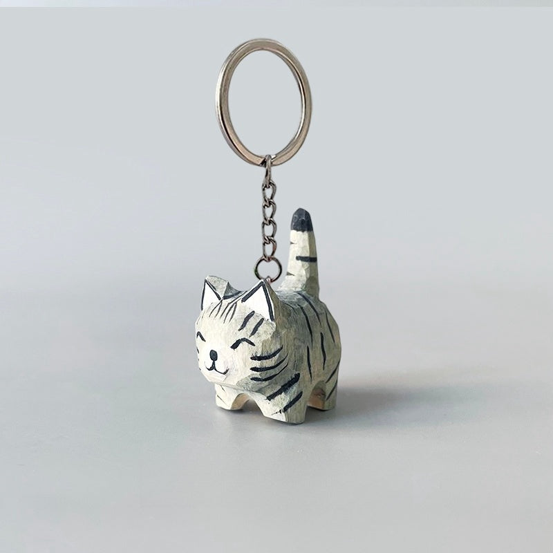 Hand-carved black stripe gray cat keychain with a smiling face.