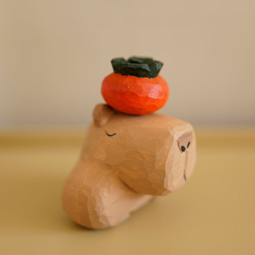 Close-up of capybara figurine, hand-carved wooden sculpture.