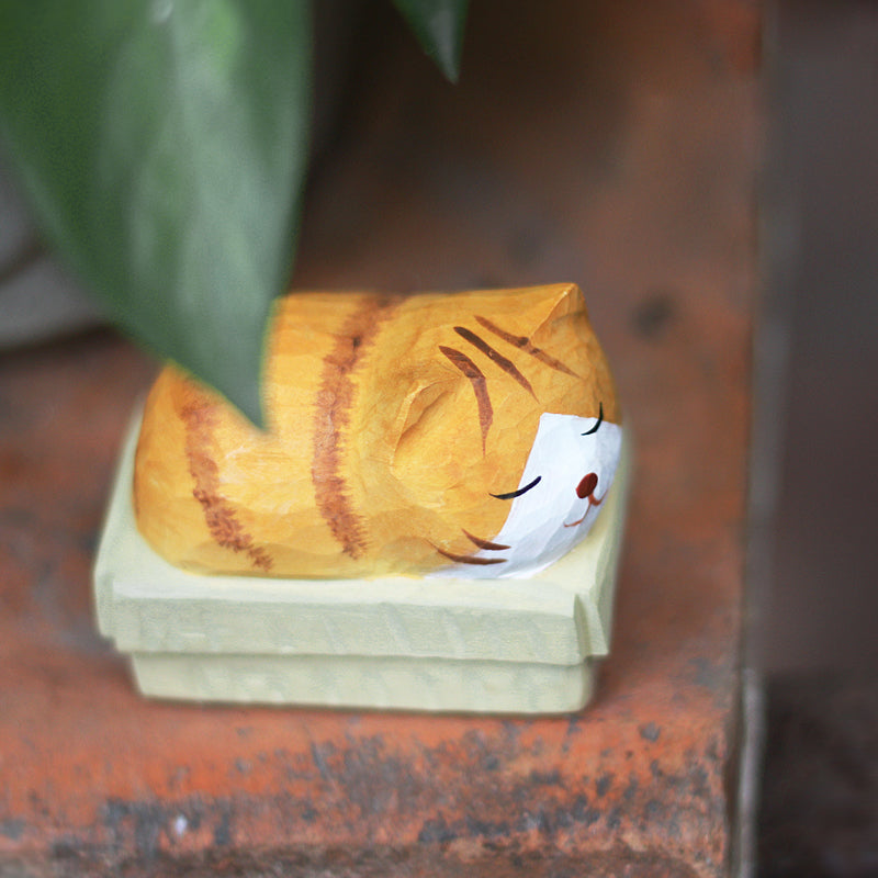 Close-up of Cardboard Sleeping Cat showing the intricate painting and wood texture.