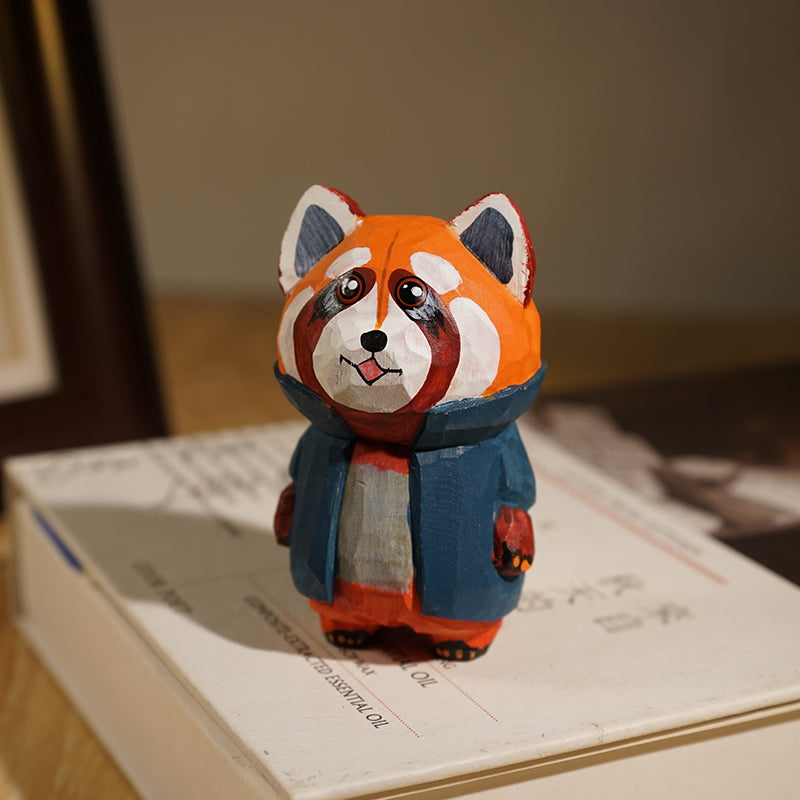 Colorful wooden red panda figurine, hand-carved with a whimsical expression and vibrant coat.