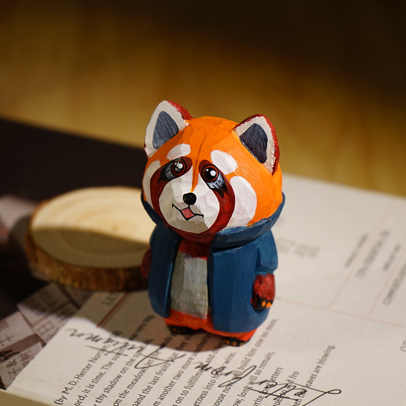 Hand-carved red panda figurine in cartoon style with a bright blue coat, showcasing detailed painting.