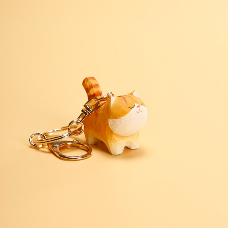 Single Chubby Orange Cat Keychain with gold ring on beige background, displaying its cute design.