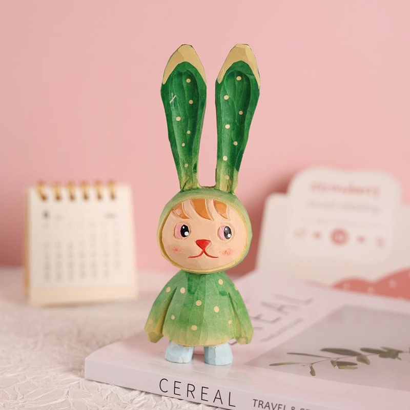 Hand-painted green easter bunny figure.