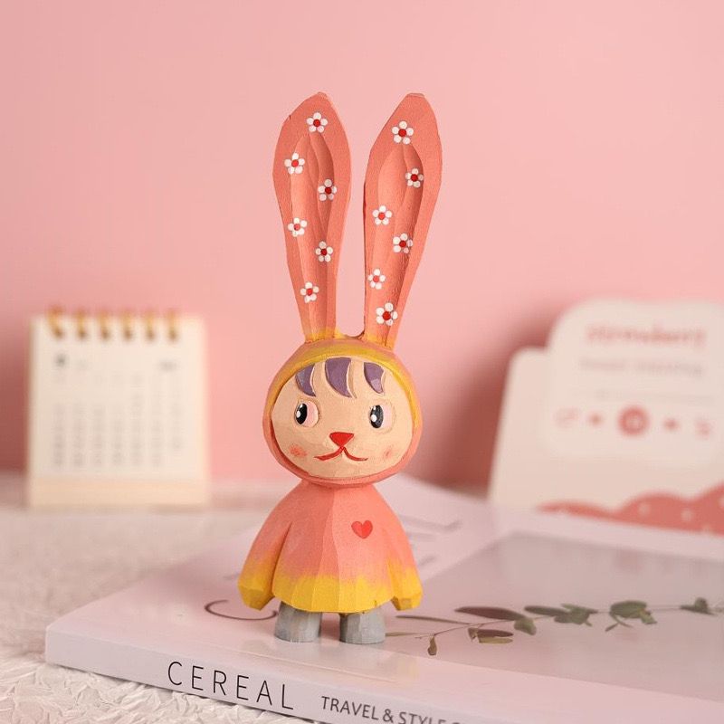 Hand-painted pink easter bunny figure.