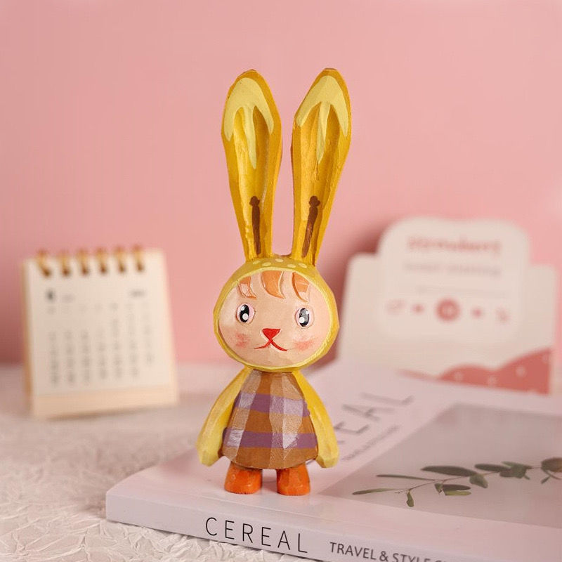 Hand-painted yellow easter bunny figure.