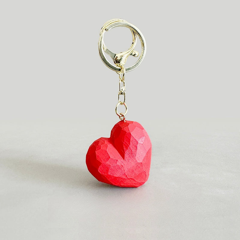 Hand-carved heart keychain in bold red color.