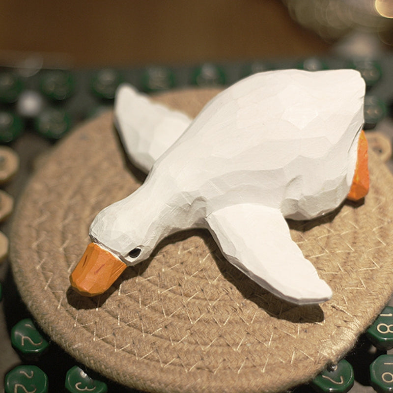 White wooden duck figure, hand-carved and painted, suitable as a gift.