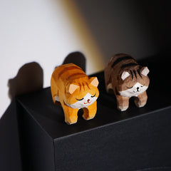 Miniature cat figurines on the bedside