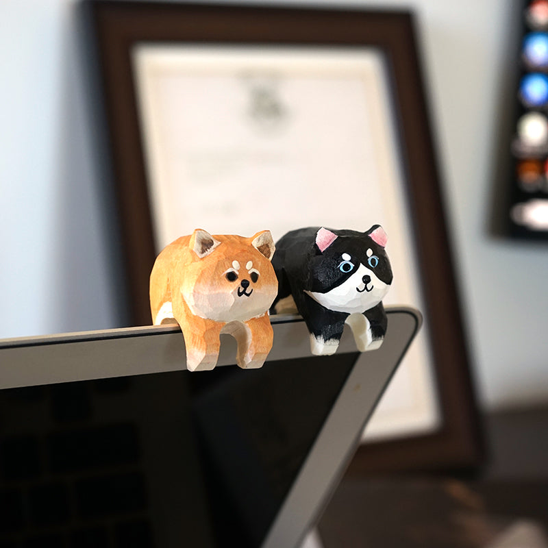 Miniature dog figurines on laptop