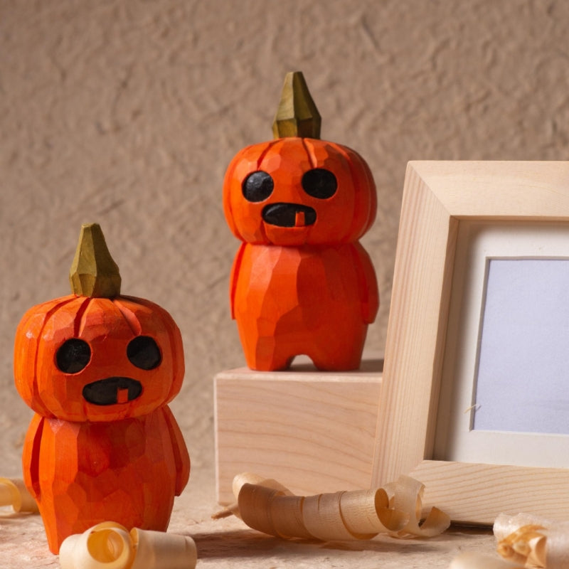 Artisanal wooden pumpkin sculpture with detailed facial features.