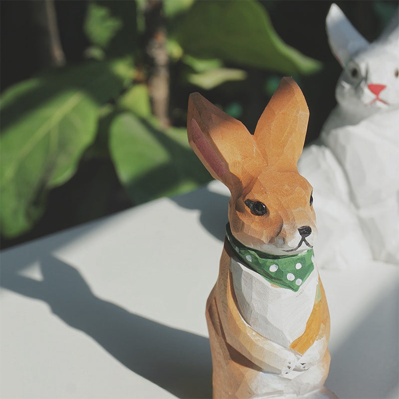 Green scarf bunny, hand-painted wooden statue.