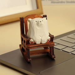 White bear figurine sitting in a rocking chair.