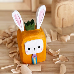 Square cartoon style bunny figure, hand-carved.