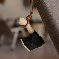 Wooden axe toy that hangs in the living room as decoration.