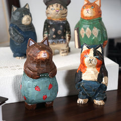 Vintage cat figurines placed on a book