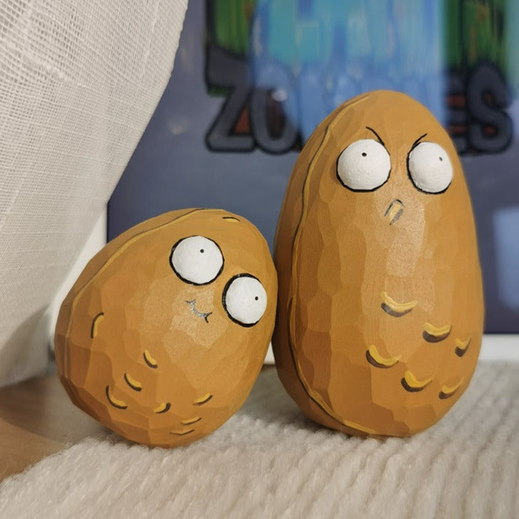 Wall-nut figurine with a surprised expression in front of a Plants vs. Zombies game background.